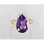 A 9ct GOLD PEAR SHAPED AMETHYST AND DIAMOND RING .