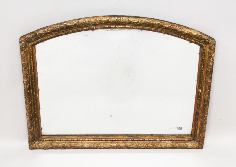 A 19TH CENTURY ARCH SHAPED OVERMANTLE MIRROR, with carved and gilded frame. 2ft 7ins wide x 2ft 1ins