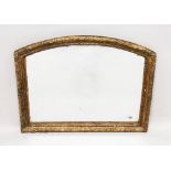 A 19TH CENTURY ARCH SHAPED OVERMANTLE MIRROR, with carved and gilded frame. 2ft 7ins wide x 2ft 1ins