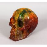 AN AMBER TYPE CARVED SKULL. 6.5ins.