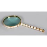 A LARGE MAGNIFYING GLASS, with mother-of-pearl handle. 1ft 7ins long.