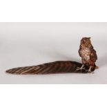 A COLD CAST INKWELL AS AN OWL STANDING ON A FEATHER. 12ins long.