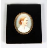 AN OVAL MINIATURE OF A LADY in white dress 2.5ins x 2ins, framed and glazed 4.5ins x 4ins.