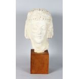 A MUSEUM COPY OF AN EGYPTIAN BUST. 11ins high on a wooden base.
