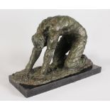 AN UNUSUAL ABSTRACT BRONZE OF A CROUCHING MAN, on a rectangular marble base. 10ins long.