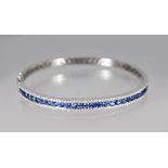 AN 18CT WHITE GOLD, DIAMOND AND SAPPHIRE BANGLE of 3.45cts.