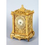 AN ORMOLU CARRIAGE CLOCK, with ornate pierced dial and case, on elephant head feet. 7ins high.