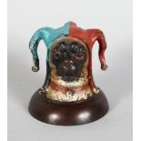 A COLD PAINTED PUG DOG JESTER INK WELL, on a circular base. 3ins high.