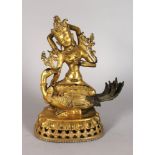 A GOOD GILDED BRONZE EASTERN DEITY, seated on a bird and lotus base. 11ins high.