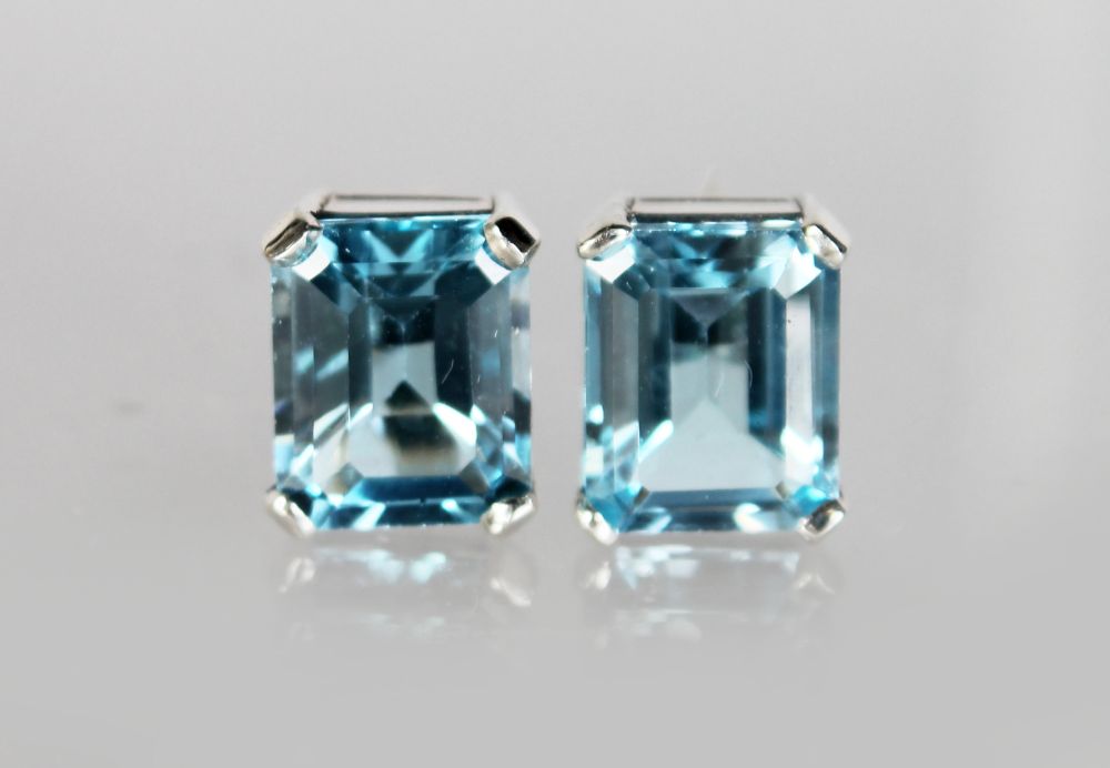 A PAIR OF SILVER EMERALD CUT BLUE TOPAZ EARRINGS.