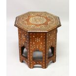 AN INDIAN OCTAGONAL SHAPED FOLDING TABLE, CIRCA 1900, with profusely inlaid floral decoration. 1ft