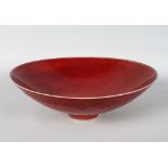 A GOOD CIRCULAR BOWL by RUPERT SPIRA, of broad conical form, with a flambe glaze, on a small