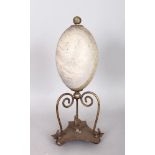 AN AUSTRALIAN MOUNTED EMU EGG, on a plated stand engraved with an eagle catching a snake. 10.5ins