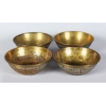 A SET OF FOUR SILVER INLAID BRASS CIRCULAR BOWLS. 4.5ins diameter.