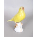 A SMALL 19TH CENTURY MEISSEN YELLOW BIRD on a tree stump. Cross swords mark in blue. 4ins high.