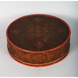 A CIRCULAR RED LACQUER BOX AND COVER. 11ins diameter.
