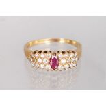 A 14K YELLOW GOLD AND DIAMOND THREE ROW DRESS RING, with a central ruby.