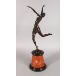 AN ART DECO STYLE BRONZE OF A YOUNG LADY, standing on one leg, arms held aloft, on a circular