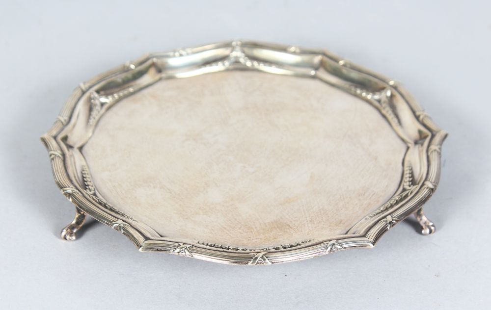 A PIE CRUST SALVER with beaded edge on three knurled feet. 7.5ins diameter. London 1909. Makers: