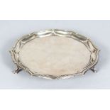 A PIE CRUST SALVER with beaded edge on three knurled feet. 7.5ins diameter. London 1909. Makers: