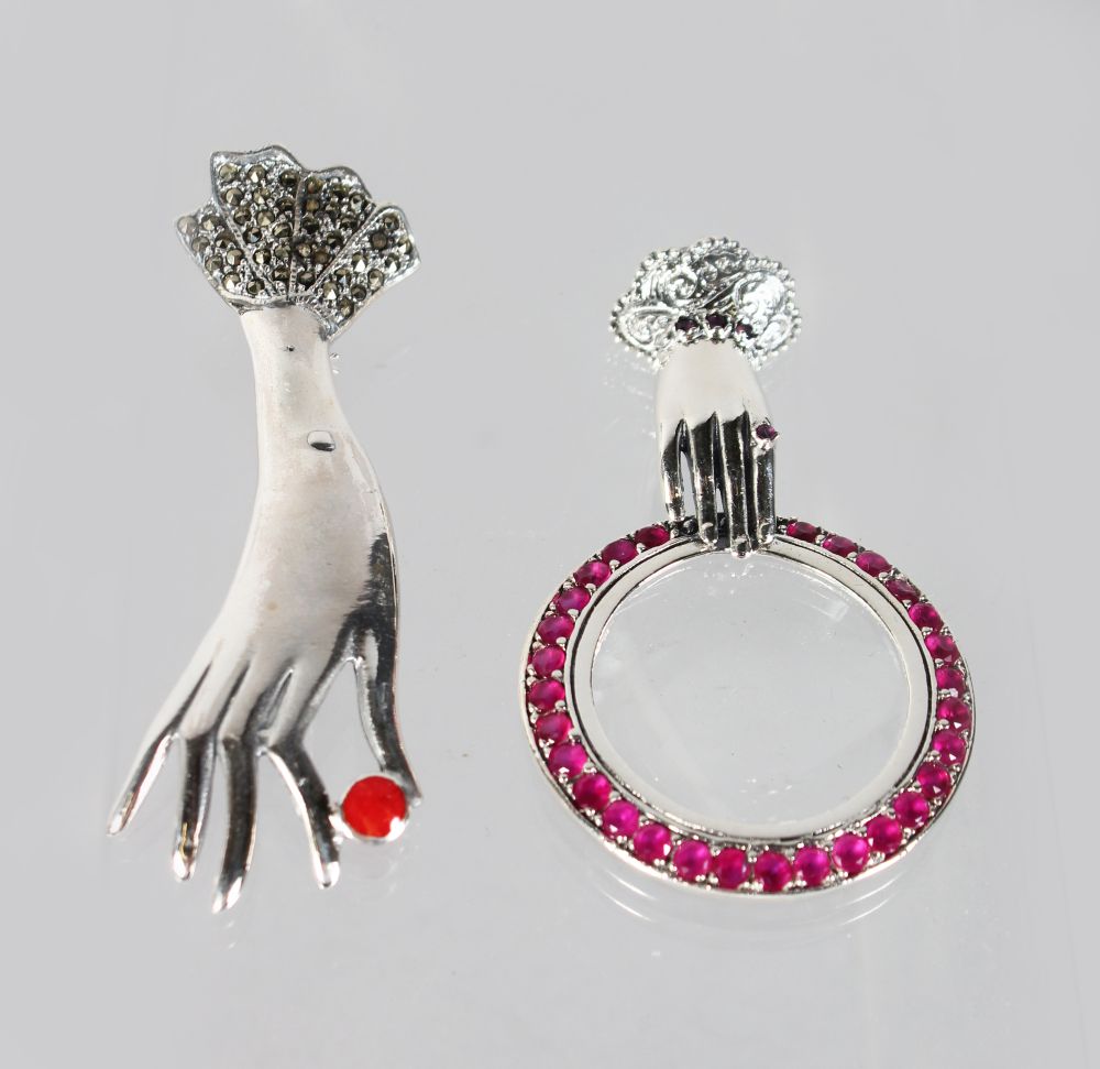 A GEM SET SILVER "HAND" MIRROR and "HAND" BROOCH (2).