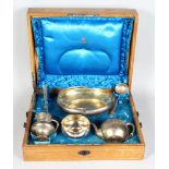 A COMPOSITE SET OF RUSSIAN SILVER, in an oak canteen comprising oval basket with swivel handle,