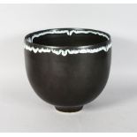 A GOOD LARGE CIRCULAR BOWL by RUPERT SPIRA, dark grey matt glaze, the rim with a white and green