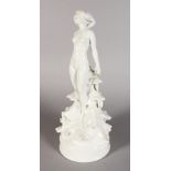 A CONTINENTAL WHITE GLAZED PORCELAIN STANDING NUDE, on a circular base. 15.5ins high.