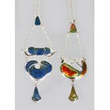 TWO SILVER AND ENAMEL ART DECO STYLE PENDANTS AND CHAINS.