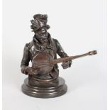 A BRONZE HEAD AND SHOULDERS OF A MAN PLAYING A BANJO, on a circular marble base. 9ins high.