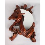 A GOOD CARVED WOOD CHERUB MIRROR with crescent shaped mirror. 23ins long.