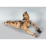 A RARE INDIAN CARVED WOOD DEITY. 19ins long.