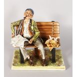 A CAPODIMONTE PORCELAIN GROUP, a man on a bench reading a newspaper, birds feeding. Signed. Mark