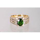 A YELLOW GOLD, DIAMOND AND GREEN STONE RING.