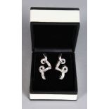 A PAIR OF 18CT WHITE GOLD DIAMOND EARRINGS set with baguette and brilliant cut stones.