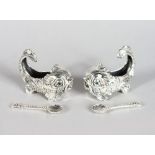 A GOOD PAIR OF SILVER DOLPHIN SHAPED SALTS AND SPOONS.
