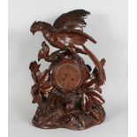 A GOOD 19TH CENTURY BLACK FOREST CARVED WOOD CLOCK, carved with pheasant and chicks and leaves,