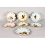 A SET OF SEVEN LIMOGES PLATES, painted with birds. 8.5ins diameter.