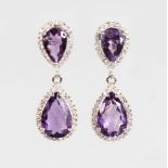 A PAIR OF SILVER PEAR SHAPED AMETHYST DROP EARRINGS.