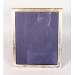 AN UPRIGHT PHOTOGRAPH FRAME with reeded edge. 11ins high x 9ins wide.