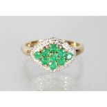 A 9CT GOLD, EMERALD AND DIAMOND RING.