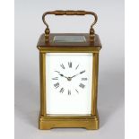 A 19TH CENTURY FRENCH BRASS CARRIAGE CLOCK striking on a gong, in a leather case. 4.5ins high.