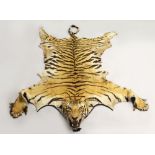 A LATE 19TH/EARLY 20TH CENTURY TIGER SKIN The mounted head depicted snarling, lined with blue baize,