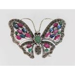 A SILVER RUBY SAPPHIRE AND EMERALD BUTTERFLY BROOCH.