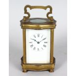 A 19TH CENTURY FRENCH BRASS SERPENTINE FRONTED CARRIAGE CLOCK. 5ins high.