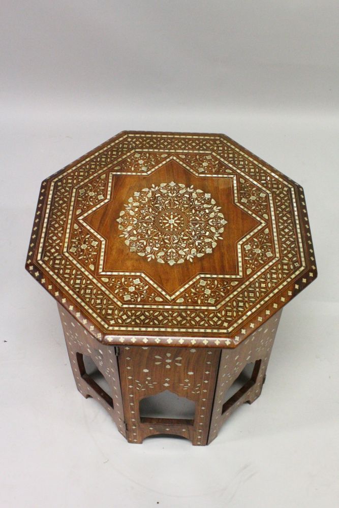AN INDIAN OCTAGONAL SHAPED FOLDING TABLE, CIRCA 1900, with profusely inlaid floral decoration. 1ft - Image 2 of 3