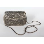 AN EASTERN WHITE METAL PURSE, with filigree decoration. 6ins wide.