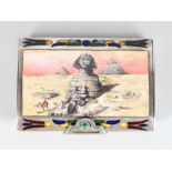 A SILVER AND ENAMEL EGYPTIAN STYLE SNUFF BOX, the lid with a sphinx. 2.75ins long.
