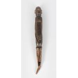 AN OLD CARVED WOOD AND METAL TRIBAL HOUSE SPIKE, head and body of a man. 14ins long.