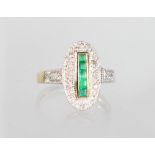 A 9ct GOLD ART DECO STYLE CALIBRE CUT EMERALD AND DIAMOND RING.